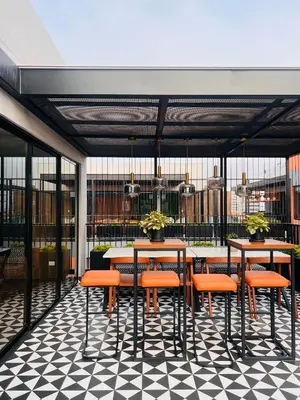 a restaurant with tables and chairs on a checkered floor at MONTERRICO POLO APARTS #17 - Dpto de estreno con Balcón Frente Embajada USA in Lima