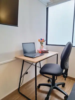 a desk with a laptop and a chair on it at Modern 1-Bedroom Apartment with WiFi in Miraflores in Lima