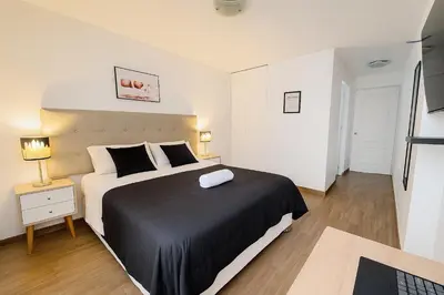 a bedroom with a large bed with a black blanket at Modern 1-Bedroom Apartment with WiFi in Miraflores in Lima