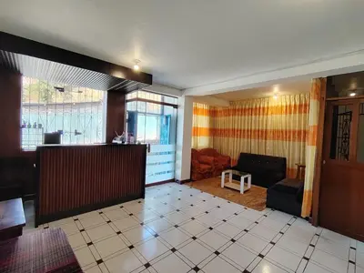 a living room with a couch and a table at Conquistador Hotel in Cusco