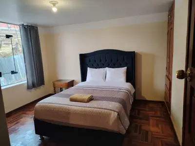 a bedroom with a bed with a towel on it at Conquistador Hotel in Cusco