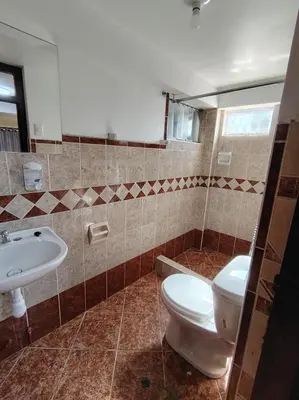a bathroom with a toilet and a sink at Conquistador Hotel in Cusco