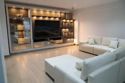 a living room with white furniture and a flat screen tv at CA3 - Casa de Lujo, Fiesta y Piscina - Punta hermosa in Punta Hermosa