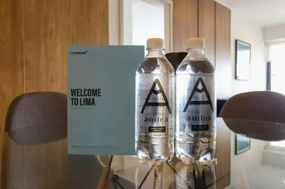 two water bottles on a glass table with a welcome touador sign at Liven in Miraflores by Wynwood House in Lima