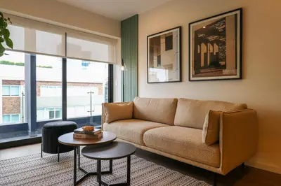 a living room with a couch and a table at Liven in Miraflores by Wynwood House in Lima