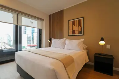 a bedroom with a large bed and a large window at Liven in Miraflores by Wynwood House in Lima