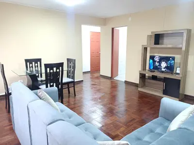 a living room with two couches and a tv at Alojamientos Perú II in Lima