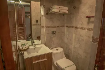a small bathroom with a toilet and a sink at Hotel Lexus in Lima
