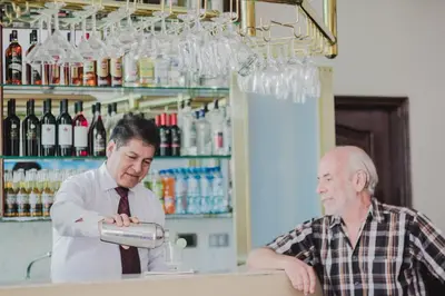 two men standing at a counter in a wine shop at Hotel Lexus in Lima
