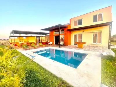 a house with a swimming pool in front of it at La Finca Ica in Ica