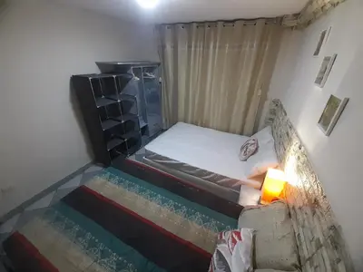 a small bedroom with a bed and a candle at Just for me in Lima