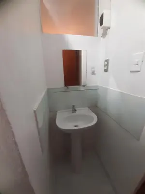 a white bathroom with a sink and a mirror at Just for me in Lima