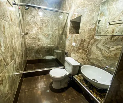 a bathroom with a toilet and a shower and a sink at Encanto de Concevidayoc in Cusco