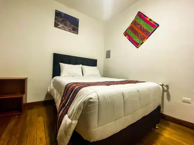 a bedroom with a large bed in a room at Encanto de Concevidayoc in Cusco
