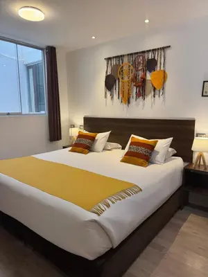 a bedroom with a large bed in a room at CASA CRISTOBAL Centenario in Cusco