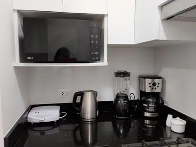 a kitchen with a counter top with a microwave at Departamento Pardo Miraflores in Lima