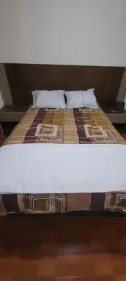 a bed with a pillow on top of it at Departamento cerca al Centro Histórico de Lima in Lima
