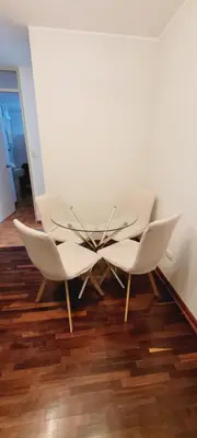 a table and chairs in a room with a floor at Departamento cerca al Centro Histórico de Lima in Lima