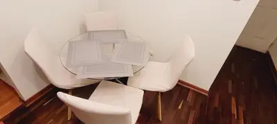 a table with white chairs in a room at Departamento cerca al Centro Histórico de Lima in Lima