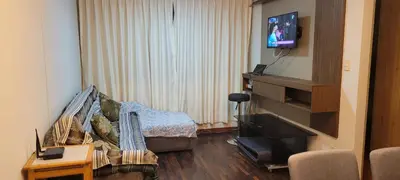 a living room with a couch and a flat screen tv at Departamento cerca al Centro Histórico de Lima in Lima