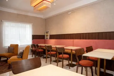 a dining room with tables and chairs and a red wall at Lima Atelier Boutique in Lima