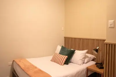 a bedroom with a bed with pillows on it at Lima Atelier Boutique in Lima