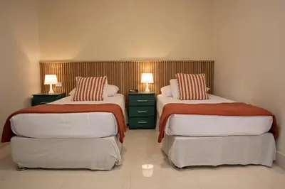 two beds in a room with two lamps on them at Lima Atelier Boutique in Lima
