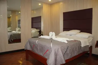 a bedroom with a bed with white towels on it at 100pre feliz in Lima