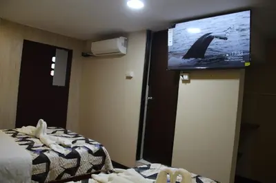 a hotel room with a flat screen tv on the wall at 100pre feliz in Lima
