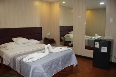 a hotel room with two beds and a mirror at 100pre feliz in Lima