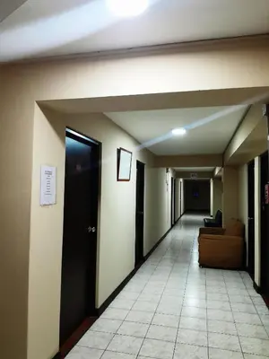 an empty hallway with a door and a couch at 100pre feliz in Lima