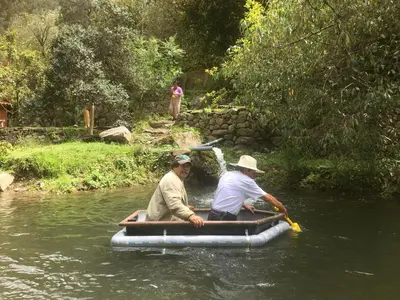 two men are in a raft in the water at HOSTEL INKA PACCHA - cascada inka in Ollantaytambo