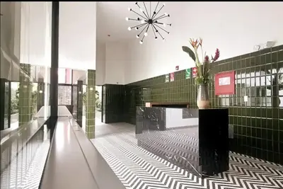 a lobby with a vase of flowers on a counter at Cómodo y silencioso Apartamento 1BR en Barranco in Lima