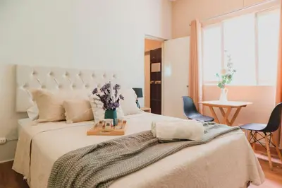 a bedroom with a large bed with flowers on it at Casa Bellido - Miraflores Private Rooms - Cocina Compartida - Wifi in Lima