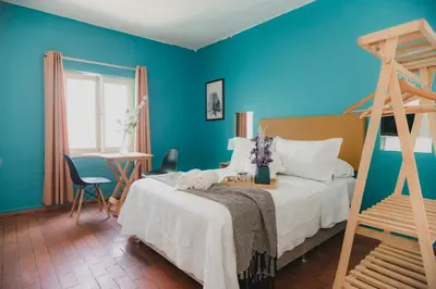 a bedroom with a bed and a blue wall at Casa Bellido - Miraflores Private Rooms - Cocina Compartida - Wifi in Lima
