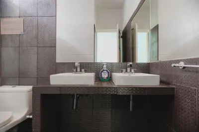 a bathroom with two sinks and a mirror at Casa Bellido - Miraflores Private Rooms - Cocina Compartida - Wifi in Lima