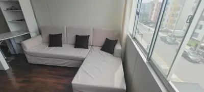 a white couch with black pillows in a living room at Departamento completo cerca al Centro Histórico de Lima y al aeropuerto in Lima