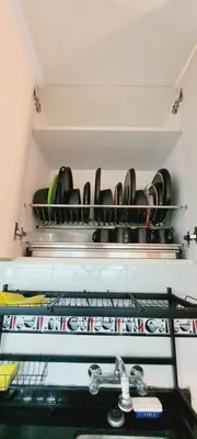 a shelf with a bunch of pots and pans at Departamento completo cerca al Centro Histórico de Lima y al aeropuerto in Lima