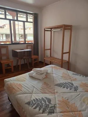 a bedroom with a bed with towels on it at Sequeiros Garden in Ollantaytambo