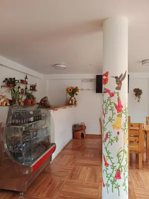 a room with a glass case with birds on the wall at Sequeiros Garden in Ollantaytambo