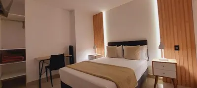 a hotel room with a bed and a desk at Mandala Lux Hotel in Pisco