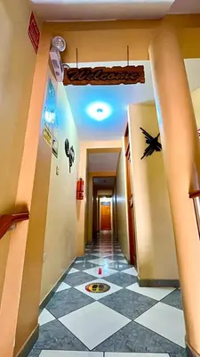 a hallway with a checkered floor in a room at Hospedaje Sol de Oro in Nazca