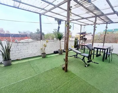 a patio with a table and a bench on a roof at Casona Turística Gonzales in Lima