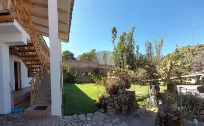 a view of the garden from the outside of a house at Hostal Miramonti in Urubamba