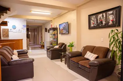 a waiting room with leather couches and chairs at Hostal Los Balcones in Nazca