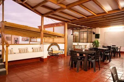 a dining room with black tables and chairs at Hostal Los Balcones in Nazca