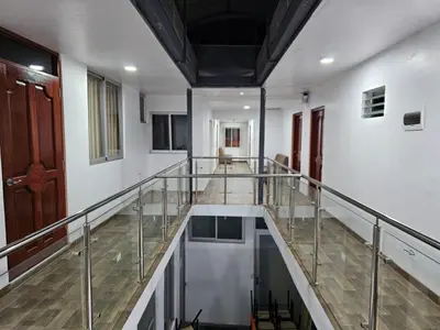 a hallway with a glass railing in a building at Hospedaje Paqcha in Cusco