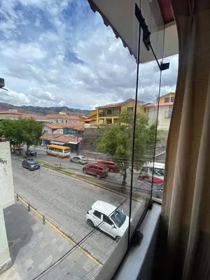 a view from a window of a street with a white car at Plaza del Inka in Cusco