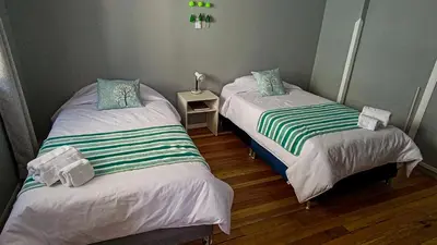 two twin beds in a room with at Les Sorciers ooo in Cusco