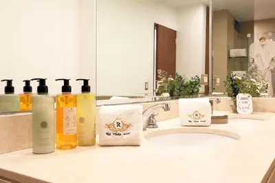 a bathroom with a sink with two bottles of soap at Rig Vêda Hotel in Lima